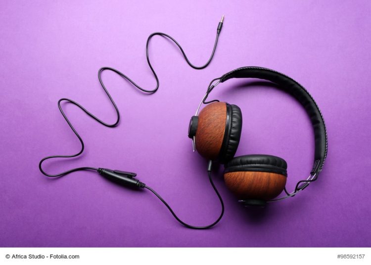 Black and brown headphones on purple background